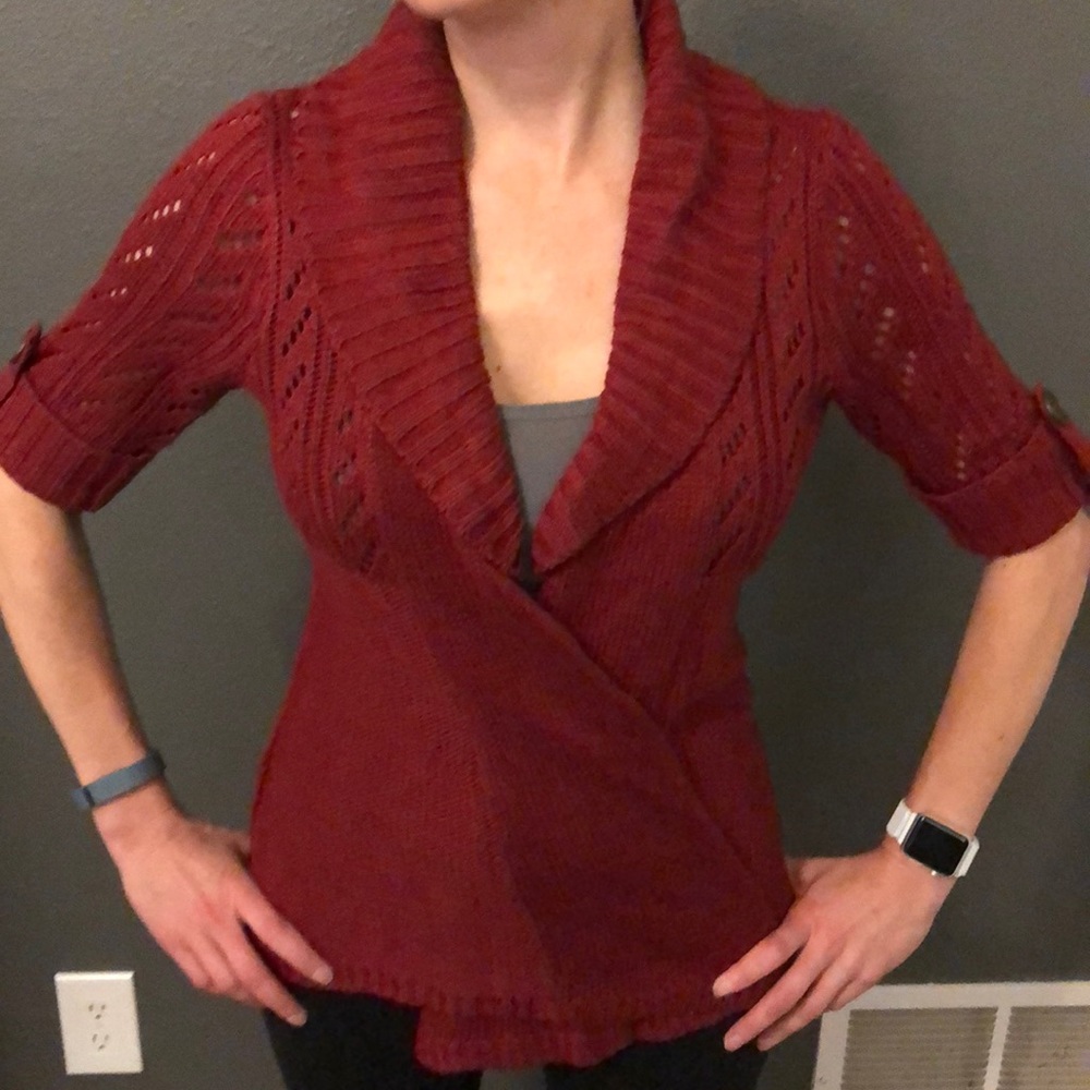Maroon open front cardigan with lace sleeves.